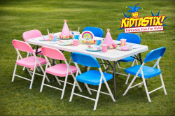 kids party table with pink and blue chairs